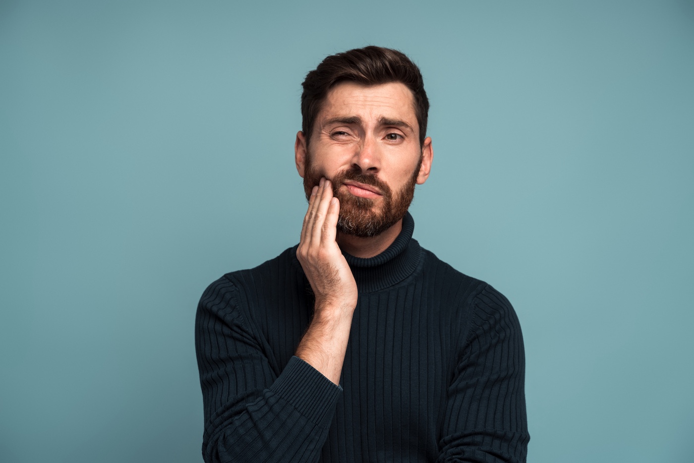 A portrait of a man having tooth problems. It's time for a tooth extraction at Smiles Dental, P.C. in Norfolk, NE